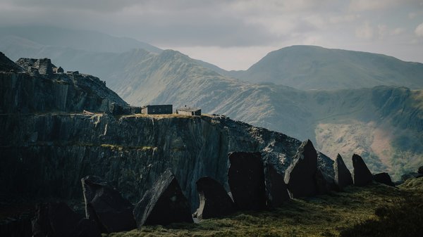 How can you participate in a guided tour of the historic quarries in Wales?